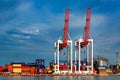 Gantry cranes at shipyard big heavy technique and trucks for logistic goods,container depot. Royalty Free Stock Photo