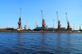 Gantry cranes on the shore of the river Royalty Free Stock Photo