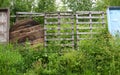 Gap in the concrete fence sealed with improvised wooden materials