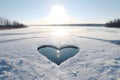 Gap in the ice in the shape of a heart around the omnipresent snow. Heart as a symbol of affection ave