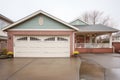 garage attached to brick colonial with driveway