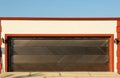 Garage building with closed sectional metal gate Royalty Free Stock Photo