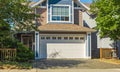 Garage door with driveway. Big modern custom house front yard and driveway to garage on a sunny summer day Royalty Free Stock Photo