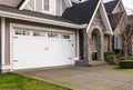 Garage Door. Modern house with garage door that is closed. A perfect neighbourhood. Family house with wide garage door Royalty Free Stock Photo