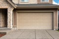 Garage Door. Modern house with garage door that is closed. A perfect neighbourhood. Family house with wide garage door Royalty Free Stock Photo