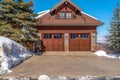 Garage entrance with two glass paned wood doors against blue sky in Park City Royalty Free Stock Photo