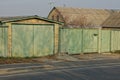 garage with green gates and part of the fence on the street Royalty Free Stock Photo