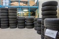 a garage, many new tyres are stacked so that they can be fitted as winter tyres Royalty Free Stock Photo