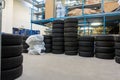 a garage, many new tyres are stacked so that they can be fitted as winter tyres Royalty Free Stock Photo