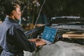 Garage mechanic car engine engineer woman staff worker using laptop computer turning engine or check ECU combustion control Royalty Free Stock Photo