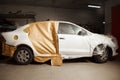 Garage painting car service. vehicle cover with protective paper before painting