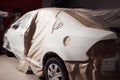 Garage painting car service. vehicle cover with protective paper before painting.