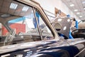 Garage with retro cars. Mechanic in classic car restoration workshop Royalty Free Stock Photo