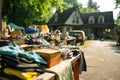 Garage sale on a sunny day. Tables with old things in front of the houses, people looking at the goods Royalty Free Stock Photo