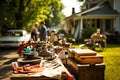 Garage sale on a sunny day. Tables with old things in front of the houses, people looking at the goods Royalty Free Stock Photo