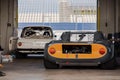 Garage with white and yellow vintage sportscars ready to race in the Assen TT Circuit, Netherlands