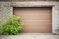 Garage wooden plank door, dirty grunge brick wall