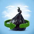 Garbage bag and green arrows from grass. Recycling concept Royalty Free Stock Photo