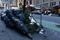 Garbage Bags and a Christmas Tree on the Sidewalk in Midtown Manhattan of New York City Royalty Free Stock Photo