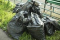 Garbage bags on the street. Black plastic bags for waste collection in the city Royalty Free Stock Photo