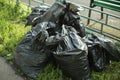 Garbage bags on the street. Black plastic bags for waste collection in the city Royalty Free Stock Photo