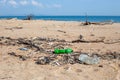 Garbage on the beach. Plastic garbage was carried out by a wave on a sandy shore. Ecological catastrophe Royalty Free Stock Photo