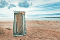 Garbage bin on beach sand in Halmstad, Sweden Royalty Free Stock Photo