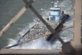 Garbage boat under the Brookyn bridge Royalty Free Stock Photo