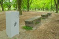 A garbage box stands in the park near the benches. Royalty Free Stock Photo