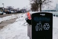 Garbage can at Chicago shoreline overflowing with Dunkin donuts bags facing the Chicago skyline Royalty Free Stock Photo