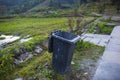 The garbage can on the edge of the field Royalty Free Stock Photo