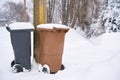 Garbage cans at the roadside on a snowed-in street in Germany Royalty Free Stock Photo