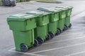 Garbage Cans In A Row Waiting For Dump Truck