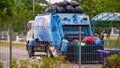 Garbage collecting truck with workers reach at early morning to collect Garbage in Housing area. Royalty Free Stock Photo