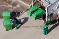 Garbage collection workers in residential area operating garbage truck