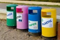 Garbage in colored trash cans with sorted garbage icons. plastic, paper, metal, glass. Sorting garbage by material and Royalty Free Stock Photo