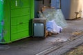 Garbage container with bags, glass and an old television on the floor