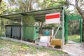 Garbage containers in fence cage / Orderly stowed garbage cans for separate garbage collection.