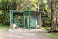 Garbage containers in fence cage / Orderly stowed garbage cans for separate garbage collection.