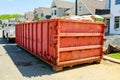 Garbage containers near the new home, Red containers, recycling and waste construction site on the background Royalty Free Stock Photo