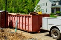 garbage containers near the new home, Red containers, recycling and waste construction site on the background Royalty Free Stock Photo