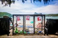 Garbage containers for separate waste collection on the tropical beach near people who sunbathing