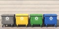 Garbage containers with separated garbage on a street. Trash bins for plastic, glass, paper and organic. Segregate waste and