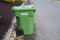 Garbage day, large plastic green yard waste bin sitting out at the curb, recycling of organics and yard waste Royalty Free Stock Photo