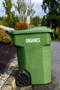 Garbage day, large plastic green yard waste bin sitting out at the curb, recycling of organics and yard waste Royalty Free Stock Photo