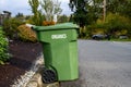 Garbage day, large plastic green yard waste bin sitting out at the curb, recycling of organics and yard waste Royalty Free Stock Photo