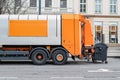 Garbage disposal lorry at city street. Waste dump truck on town road. Municipal and urban services. Waste management, disposal and