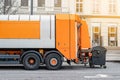 Garbage disposal lorry at city street. Waste dump truck on town road. Municipal and urban services. Waste management, disposal and Royalty Free Stock Photo