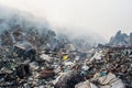 Garbage dump area view full of smoke, litter, plastic bottles,rubbish and other trash at the Thilafushi local island Royalty Free Stock Photo