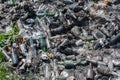 Garbage dump of burnt glass bottles, top view, closeup